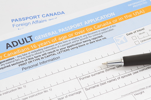 A Canadian Passport application.  The envelope to mail it in can be seen in the background.