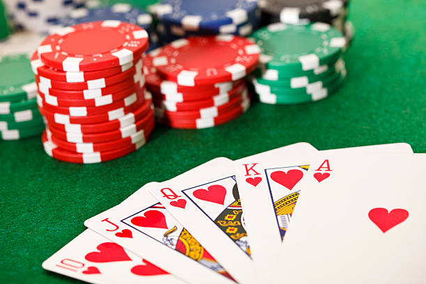 Poker, royal flush and gambling chips. Poker cards showing the best poker hand -royal flush- and poker chips on a green card table. This is an exclusive image and it can only be found in iStockphoto. poker card game stock pictures, royalty-free photos & images