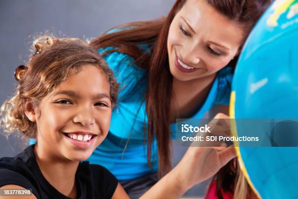 Happy Elementary Student Learning About Geography With Globe In Class Stock Photo - Download Image Now