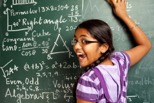 Cheerful Indian Girl Student Erasing Mathematics Problems from Greenboard
