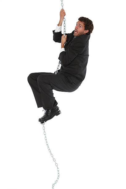 istock Businessman hanging from a metal chain 183779263