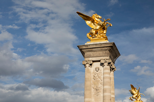 One of the four gilt-bronze sculptures by Pont Alexandre III in Paris. They represent Fames restraining Pegasus.