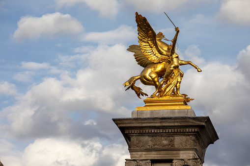 One of the four gilt-bronze sculptures by Pont Alexandre III in Paris. They represent Fames restraining Pegasus.