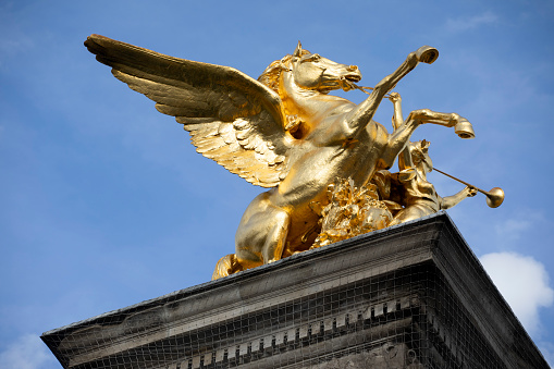 One of the four gilt-bronze sculptures by Pont Alexandre III in Paris. They represent Fames restraining Pegasus.