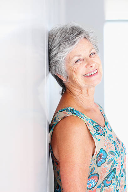istock Attractive senior woman leaning against wall 183779584