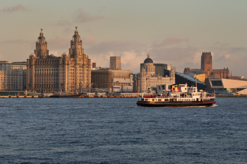 The Ferry across the Mersey and the Liverpool Skyline bathed in the last rays of the setting sun.