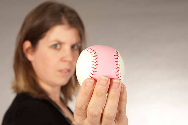 istock women showing baseball ball 183779683