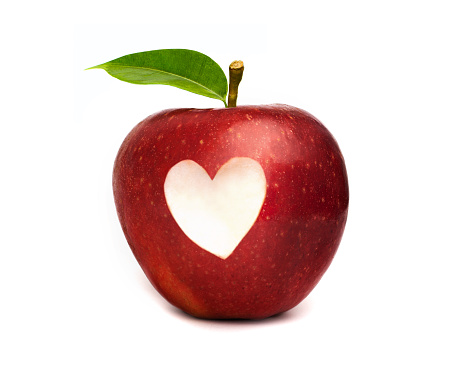 Red apple with a heart symbol isolated on white