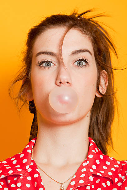 istock Young woman blowing bubblegum 183779911