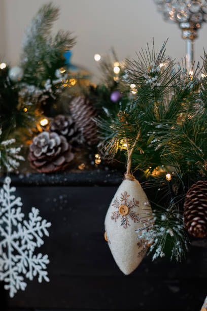 istock Christmas background with pine branch and beautiful yellow shiny bokeh. Wool pine cone. White snowflake. Shallow depth of field 1837800257