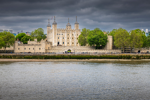 the infamous tower of london from across the river thames in london, england
