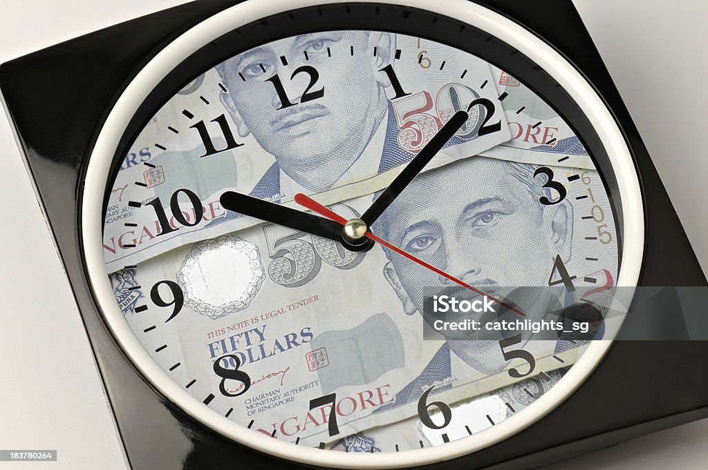 Time and Money Wall clock with Singapore Currency Notes as clock face. Business Stock Photo