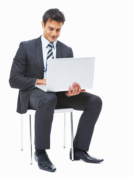 istock Happy executive seated on chair and using laptop 183780423