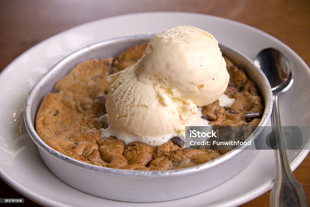 Warm Chocolate Chip Cookie Pie Pan & Melting Vanilla Ice Cream "Baked, warm chocolate chip cookie in pie pan & melting vanilla ice cream. (SEE LIGHTBOXES BELOW for more dessert sandwich treats & sweet food...)" Chocolate Chip Cookie Stock Photo