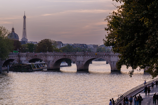 Paris, France - October 8, 2023 : View of a typical bridge and the Eiffel Tower in the background in Paris France at sunset