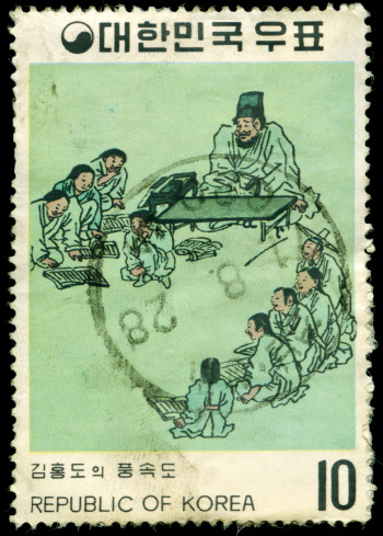 Old stamp with drawing of a classroom with students and a teacher, scanned on black background. In aRGB colorspace for optimal printing. Postmarked 1971.