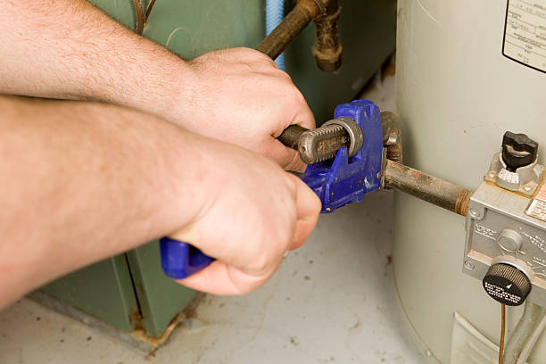 istock Repairman Tightens Gas Pipe with a Monkey Wrench 183782793