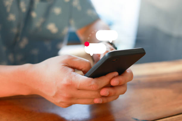 close up young man hand hold smartphone and contact another by using chat inbox to communicate and discussion about work or service support for business concept