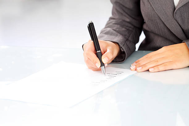 istock Focus on human hand - woman signing a contract. 183784004