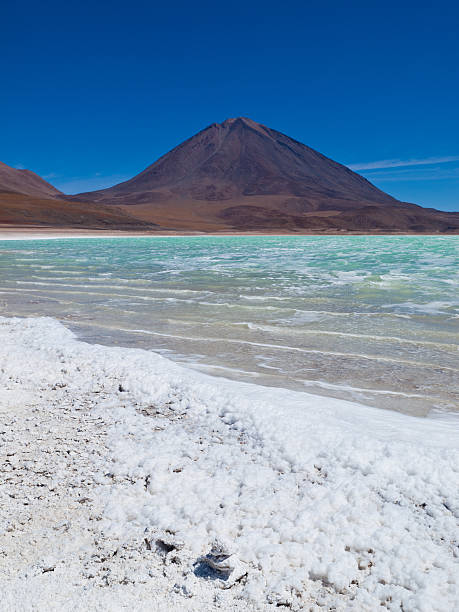 Laguna Verde Green Lake Salar de Uyuni in Bolivia Laguna Verde (Green Lagoon) Lake at Salar de Uyuni Salt Flats in Bolivia with dried salt in the foreground. salar de uyuni stock pictures, royalty-free photos & images