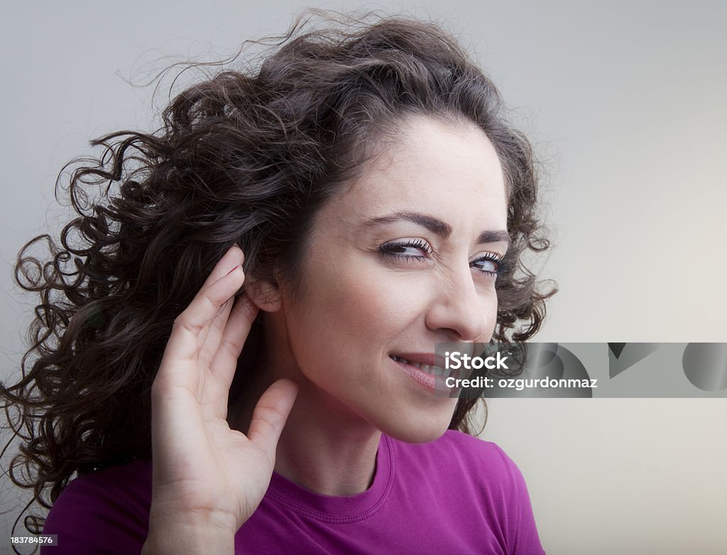 Can't hear you "Young woman cupping hand to ear, trying to listen something, close-up portrait." Ear Stock Photo