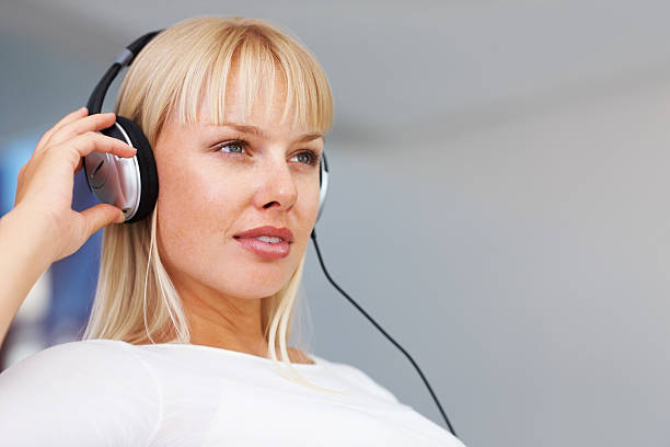 istock Woman listening to music while looking away 183784880