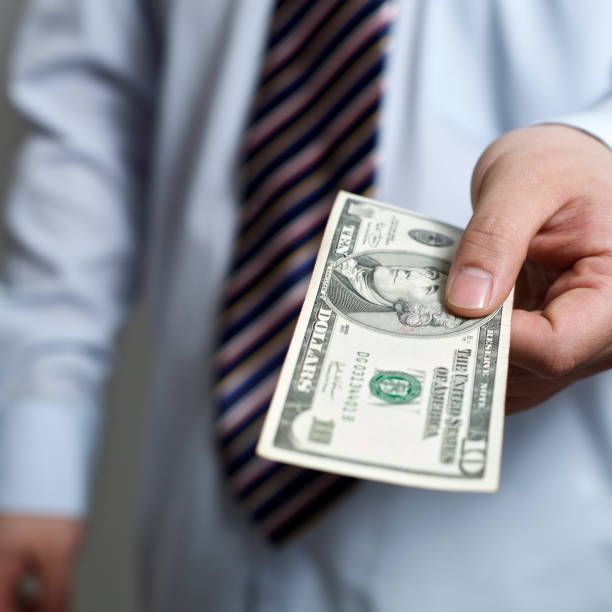 istock Busniessman giving 10 dollars 183784987