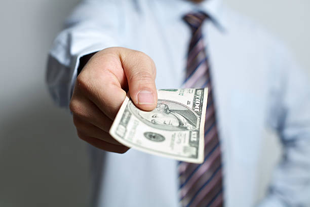 istock Busniessman giving 10 dollars 183784990