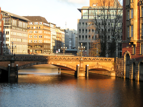 Late afternoon Golden view of the canals in Hamburgs speicherstadt district. The Speicherstadt is a district located in the Port of Hamburg, Germany, and it is the largest warehouse district in the world where the buildings stand on timber-pile foundation