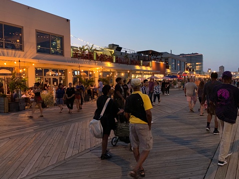 Asbury Park, NJ, USA July 27, 2019 People enjoy walking on the boardwalk in Asbury Park New Jersey on a warm summer night