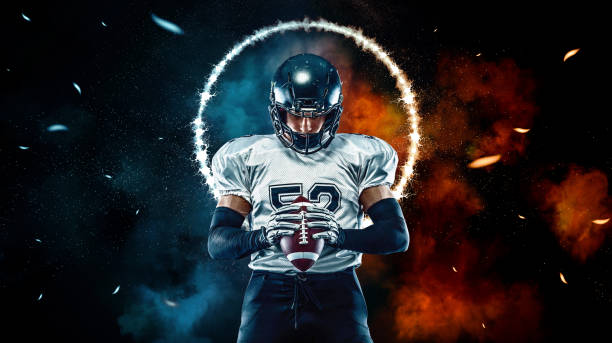 American football player black background with fire stock photo