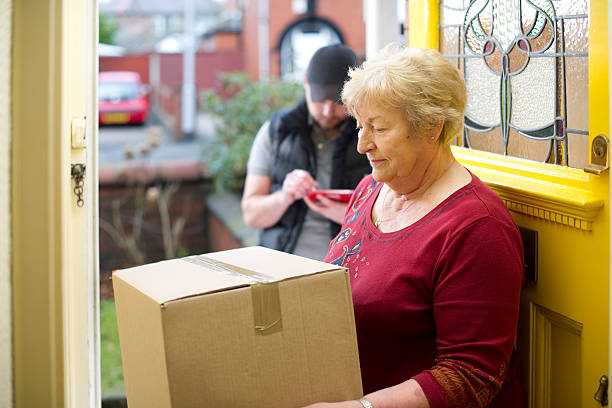istock Delivery man delivers grans parcels 183791740