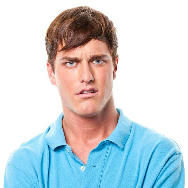 Confused Young Man Frowning Portrait of a man on a white background. http://s3.amazonaws.com/drbimages/m/evamag.jpg confused face stock pictures, royalty-free photos & images