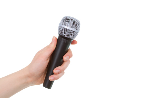 Female hand holding a wireless microphone on white