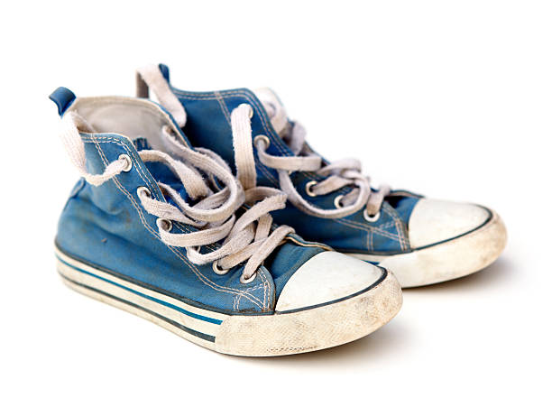 Blue Sneakers "Old dirty blue sneakers, isolated on white background." pair of shoes stock pictures, royalty-free photos & images