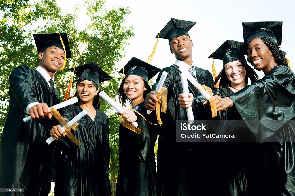 Graduates A diverse group of graduates holding their diplomas.   . 20-24 Years Stock Photo