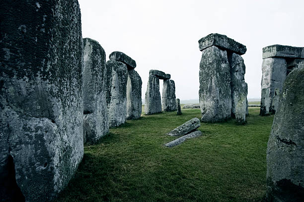 Surreal composition with Stonehenge and old clock.