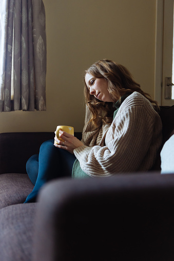 Woman drinking coffee at home