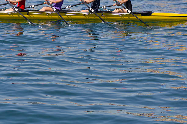 Teamwork. Group of people working together, with copy space over the water.