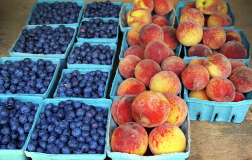 Blueberries and Peaches in quart and pint baskets for sale at a farmer's marketClick on banners below for similar images: