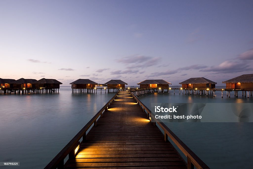 wooden walkway to villas In Maldives Blue Stock Photo