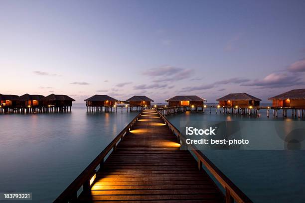 Wooden Walkway To Villas Stock Photo - Download Image Now - Blue, Boardwalk, Footpath