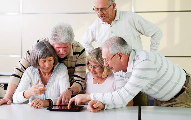 istock School for seniors... senior students having fun with computer 183793326