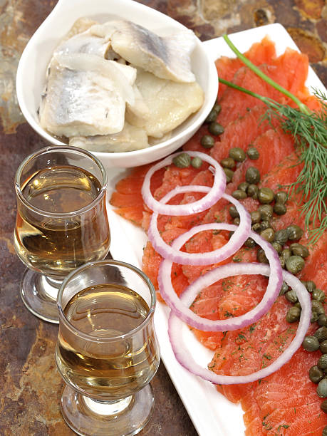 Gravlax (gravad lax, gravet laks, gravlaks) "Scandinavian Salt and Sugar cured salmon platter with fresh dill, red onion and capersPickled herring and onions, schnapps or caraway liquor" gravad stock pictures, royalty-free photos & images