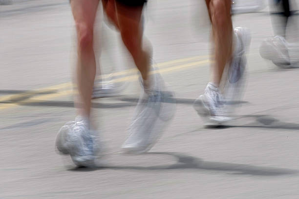 istock Blurred Marathon Runners Legs Feet 183793822