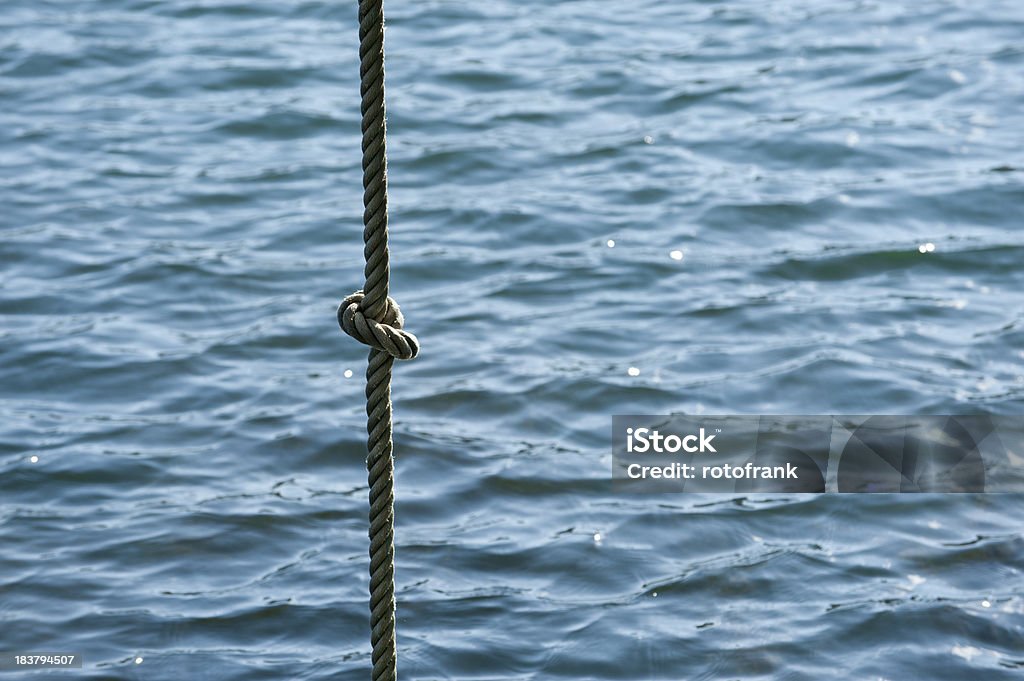 Rope with a knot in front of water Community Stock Photo