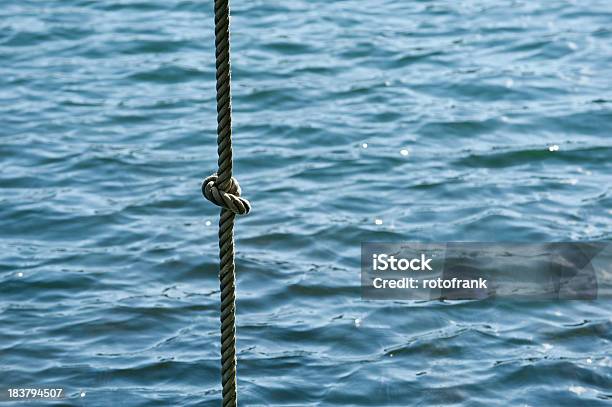 Rope With A Knot In Front Of Water Stock Photo - Download Image Now - Community, Concepts, Connection