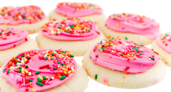 Stock photo of some sugar cookies with pink frosting.