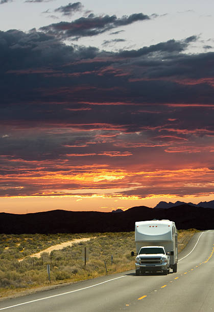 istock A large white truck driving down a road at sunset 183794918