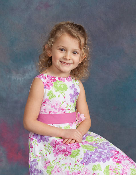 Young Girl Studio School / Yearbook Portrait Age 4 Portrait of a four-year-old girl with against a studio background.  Model is smiling and quite happy.See other related images here: school picture stock pictures, royalty-free photos & images